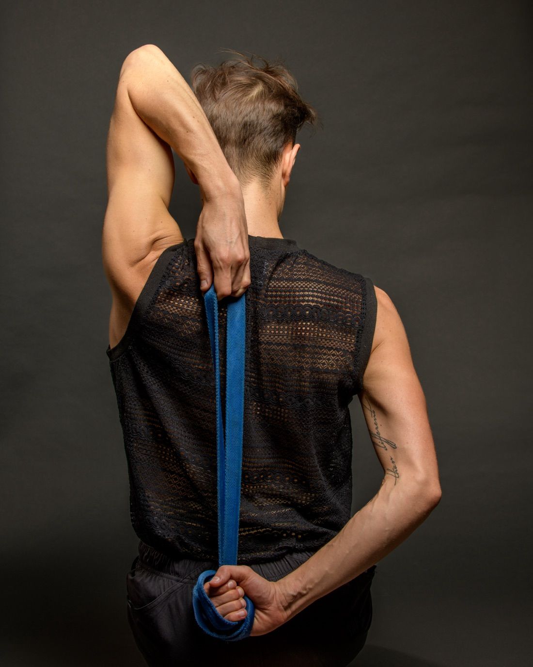 Mateo in a quiet studio, working through a guided mobility stretch
